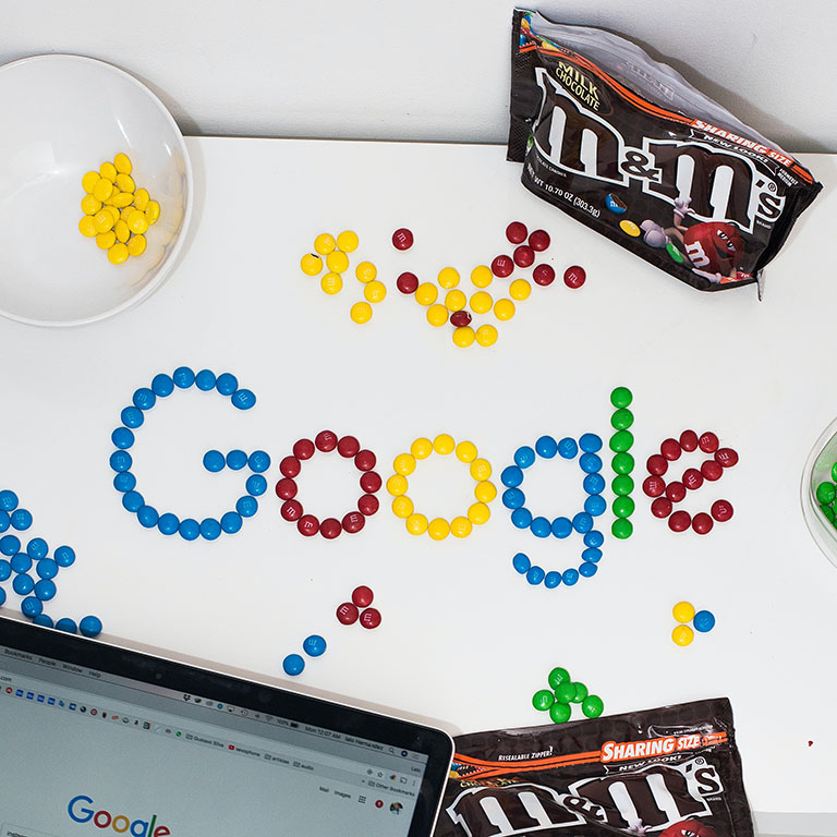 m and ms on a table spelling out Google